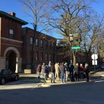 AHA tour participants by the Arcade building